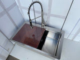 Stainless steel kitchen sink with a modern faucet